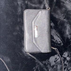 A black and silver nine west purse